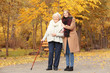 © Africa Studio - Senior woman with cane and young caregiver in park