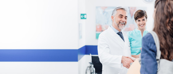 Wall Mural - Doctor and patient shaking hands