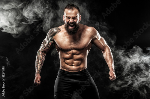 Sportsman muay thai boxer celebrating victory on black background with smoke Fototapet
