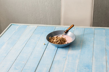 Canvas Print - Plate of cereals with yogurt on wooden table