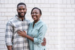 Young African couple smiling while standing together in the city
