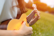 Closeup Of Girl Playing Ukulele In Garden With Acoustic Guitar, Young Woman Play Music Lifestyle Classic