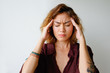 © Mangostar - Portrait of tired young woman having headache