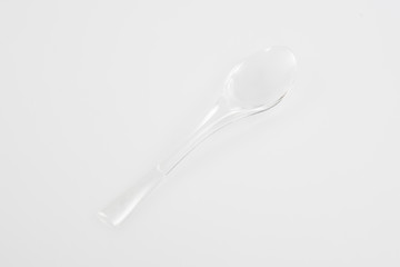 Canvas Print - Plastic silverware spoon in white background