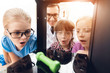 © VadimGuzhva - Children print different items on a 3d printer with a teacher.