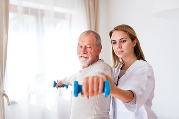 Health visitor and senior man during home visit.