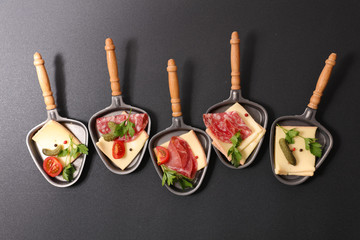 Wall Mural - assorted spoon of raclette cheese
