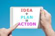 © lobro - Man holding a tablet device with text idea plan action on the screen