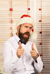 Poster - Guy on wooden wall background with red garlands