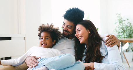 Wall Mural - Happy family watching television at their home