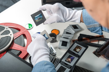 woman photographer looking at film slide