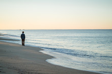 Man Watching The Sunrise And Walking Around On The Beach In Portugal