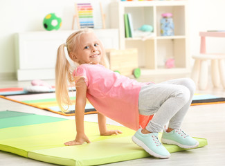 Canvas Print - Cute little girl playing in kindergarten