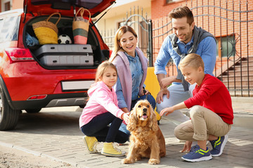 Wall Mural - Young family with children and dog near car