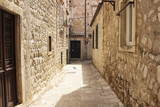 Fototapeta Uliczki - Pigeon rests on one of narrow streets in Dubrovnik old town.
