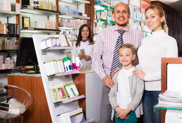 Wall Mural - Family with a kid in pharmacy .