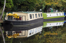 Barges Converted Into Houseboats Moored On A Canal Near Hebden Bridge In Yorkshire In Woodland