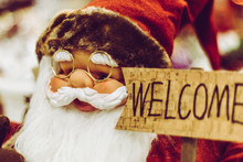Santa Claus Figurine Holding Welcome Sign