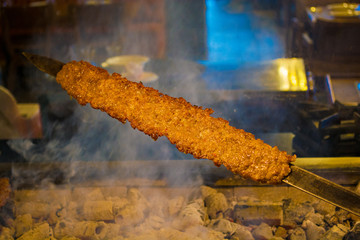 Wall Mural - rows of juicy beef kebab koobideh on grill