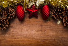 Christmas Decoration Border With Gold Tinsel And Red Baubles On Wood Background