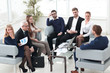 © ASDF - senior businessman and business team sitting in the lobby of the modern office.