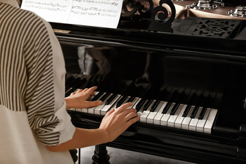 Sticker - Talented woman playing piano indoors