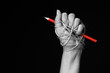 © Siam - Hand with red pencil tied with rope, depicting the idea of freedom of the press or freedom of expression on dark background in low key. international human rights day concept.