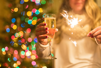 Girl holding champagne and sparkler