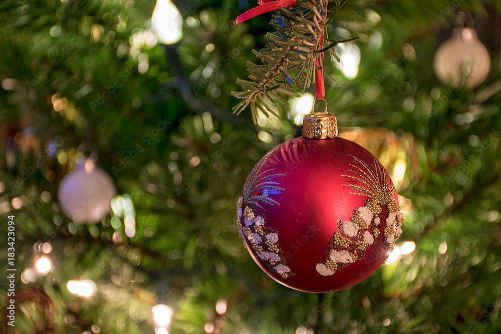 close up of elegant red and gold glittery ornament on Christmas pine ...