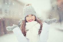 Beautiful Smiling Young Woman In Warm Clothing. The Concept Of Portrait In Winter Snowy Weather
