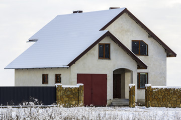 New two story residential house with stone fence in front