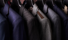 Mens Suits On Hangers In Different Colors