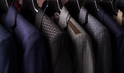 Mens suits on hangers in different colors