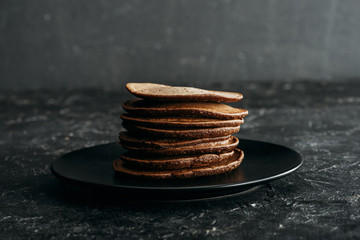 Wall Mural - stack of delicious chocolate pancakes on black plate