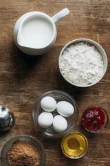 Wall Mural - top view of ingredients for pastry on wooden table