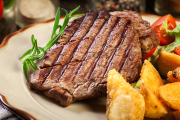 Wall Mural - Succulent portions of grilled fillet mignon served with baked potatoes