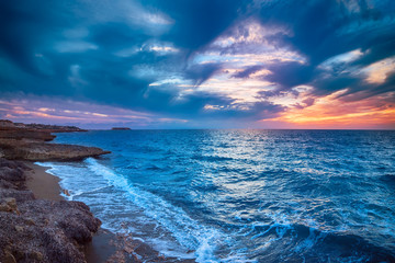 Beautiful colorful sunset at the sea with dramatic clouds and colorful sky. Beauty world natural outdoors travel background