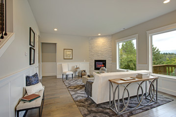 Luxury living room features corner stone fireplace