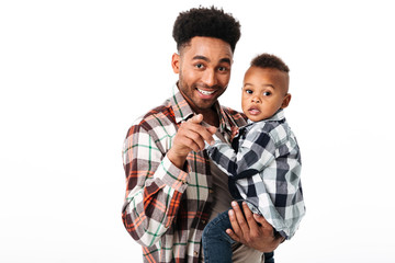 Wall Mural - Portrait of a smiling african man holding his little son