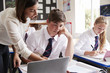 © Monkey Business - Female Teacher Helping Pupil Using Computer In Classroom
