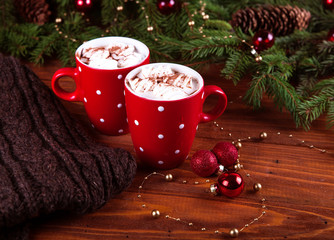 Christmas hot chocolate with marshmelow on a dark wooden background, christmas tree branches decorating. top view, horizontal composition