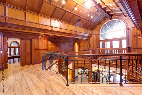 Second Floor Landing Accented With Wood Paneled Walls And Ceiling
