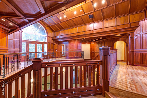 Second Floor Landing Accented With Wood Paneled Walls And