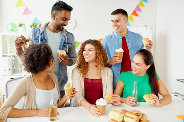 Canvas Print - happy friends or team eating at office party