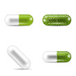 Set of pills in capsule shapes and forms. Two-piece tablets with green granules inside them. Medicine and drugs.