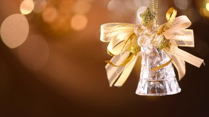 Poster - Christmas and New Year golden bell decoration. Abstract blinking holiday background. Slow motion 4K UHD video footage. 3840X2160