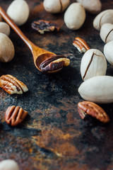 Poster - Pecan nut and wooden spoon on rustic table.