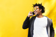 © santypan - Portrait of handsome afro man using his mobile.