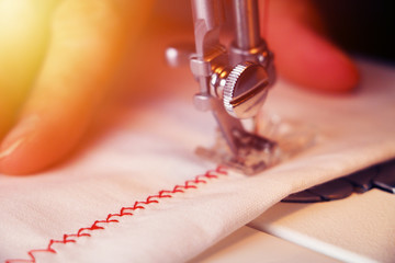 Wall Mural - sewing machine red thread woman hands