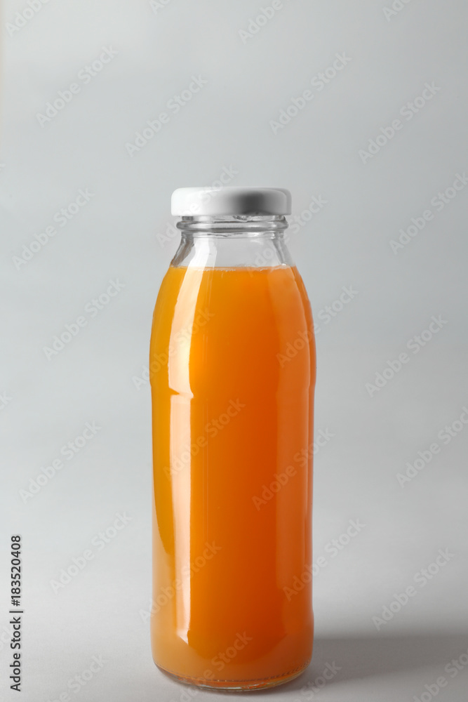 Bottle with juice on light background